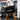 Person holding a black duffel bag with 'aquilo' branding in a gym setting